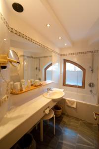 a bathroom with a sink and a shower at Ortners Eschenhof - Alpine Slowness in Bad Kleinkirchheim