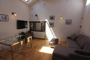 a living room with a couch and a table at 2 leather lane in Ulverston