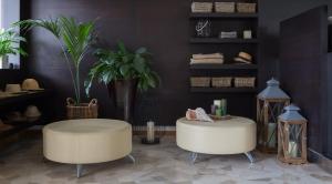 a living room with two chairs and a plant at Harvey Suites Hotel & Residence in Lido di Jesolo