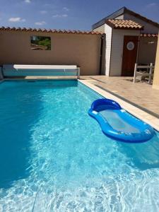 a blue plastic raft in a blue swimming pool at Charmant Studio en Champagne - Sparkling-Life in Matougues