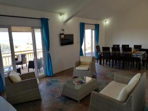 a living room with chairs and a dining room at Gite Patriko in Rodrigues Island