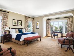 a bedroom with a bed and a table and chairs at The Langham Huntington, Pasadena in Pasadena