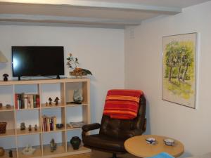 uma sala de estar com uma cadeira e uma estante de livros em Jysse's Bed & Bath em Nykobing Sjaelland