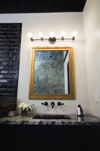 a bathroom with a sink and a mirror at GunRunner Boutique Hotel in Florence