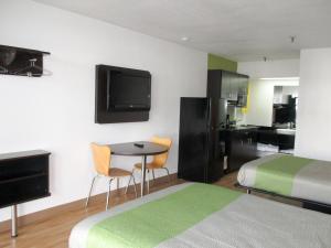 Una habitación de hotel con una cama y una mesa con sillas. en Studio 6-Alexandria, LA, en Alexandria