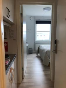 a bedroom with a bed and a window in a room at Hotel Nuka in Ilulissat