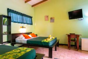 Postel nebo postele na pokoji v ubytování Hotel Boutique La Casa de las Flores