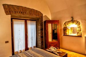 A bed or beds in a room at Il Castelletto del Salamaro