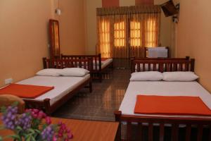 Postel nebo postele na pokoji v ubytování Anura Guest Inn + 37 fotografií