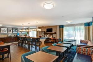 a living room with tables and chairs and a bar at Hampton Inn Columbia-I-26 Airport in Columbia