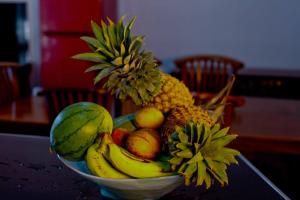 a bowl of fruit sitting on a table at HOSTEL KATUNAYAKE At COLOMBO AIRPORT TRANSIT in Katunayake