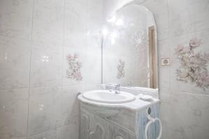 a white bathroom with a sink and a mirror at Home & Private Terrace WIFI + AIRCON in Madrid