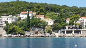a group of houses on the shore of the water at Family Desin Apartments in Molunat