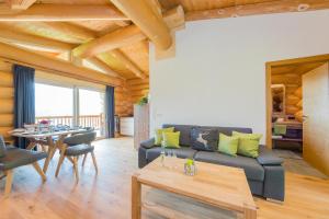 a living room with a couch and a table at Ferienhaus Obwallhof in Fieberbrunn