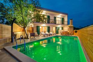 a swimming pool in front of a house at Villa Nika in Bisko