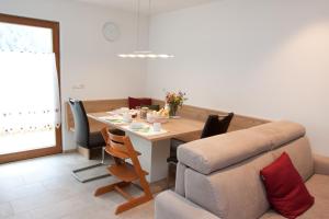 a living room with a table and a couch at Schweinsteghof Urlaub auf dem Bauernhof in Sarntal +22 photos
