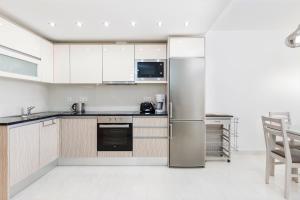 a kitchen with a stainless steel refrigerator at Victory Village 9F in Quinta do Lago