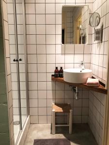 a bathroom with a sink and a mirror at The Old Garage in Tilburg