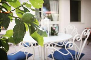 a table and a plant with a green lemon on it at Il Sole di Mondello in Mondello