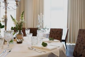 a dining room table with a white table cloth at König`s Hotel am Schlosspark in Rheda-Wiedenbrück