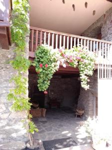 a patio with a staircase with flowers on it at Appartamento tipico in borgo in Morgex