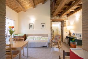 a living room with a bed and a table at Country House Villa Sabrina in San Ginesio