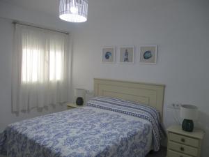ペニスコラにあるApartamento recién reformado y climatizado en ubicación inmejorable.のベッドルーム1室(青と白の毛布付きのベッド1台付)