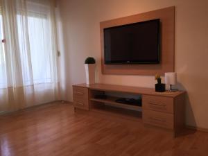 a living room with a flat screen tv on a wall at Apartment Natasa in Rab
