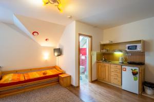 a kitchen with a bed in the middle of a room at Penzion Agáta in Žehrov