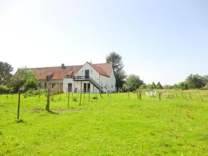 a house in the middle of a field with vineyards at Ferme Lenfant in Ville-Pommeroeul