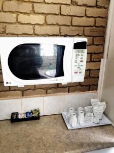 a microwave oven sitting on top of a brick wall at Tropicana Motor Inn in Cowes