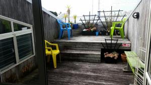 a set of stairs with colorful chairs on it at Loft 109 Backpackers Hostel in Tauranga