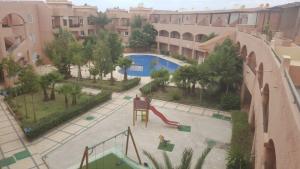 a view of a park with a slide and a playground at Beau Duplex à Imi ouaddar in Agadir nʼ Aït Sa