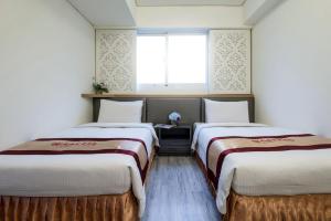 Postel nebo postele na pokoji v ubytování Harmonious Hotel
