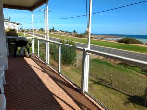 a balcony with a view of a road at Seafront Shack in Port Hughes