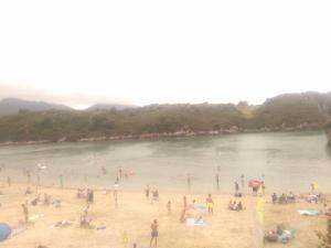 a group of people on a beach near a body of water at Villa maria in poo de Llanes