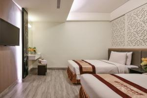 Postel nebo postele na pokoji v ubytování Harmonious Hotel