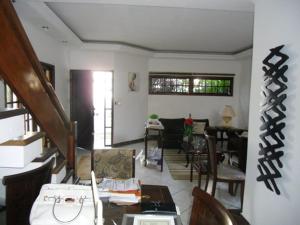 a living room with a staircase and a dining room at Casa de Férias Mãe Maria in Aparecida