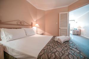 a bedroom with a large bed and a large window at Il Palazzo Holiday Apartments in Cairns