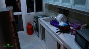a kitchen with a sink and a stove at Appart M'Rode Baguida in Lomé