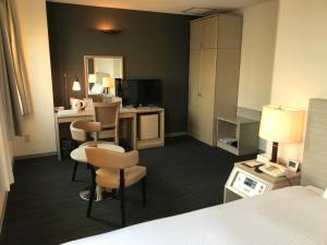 Postel nebo postele na pokoji v ubytování Chisun Hotel Kamata
