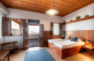 A bed or beds in a room at Thea Villas and Suite