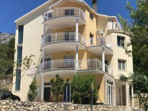 a large yellow building with white balconies on it at Vacation Rentals Croatia in Split