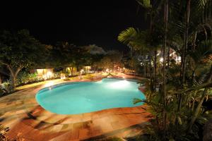 an empty swimming pool at night at Kokopo Beach Bungalow Resort in Kokopo