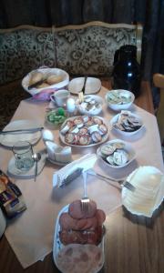 a table with many plates of food on it at Zum Holzwurm in Mühlanger