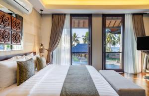 Voodi või voodid majutusasutuse Sundancer Residences and Villas Lombok toas