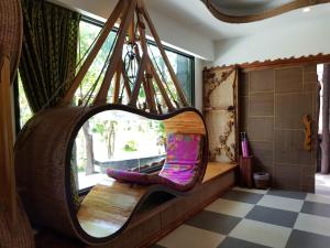 a swinging chair in a room with a window at AC 2 Resort in Koh Tao