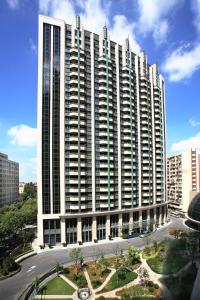 a large tall building with a street in front of it at Grand Mercure Shanghai Hongqiao in Shanghai