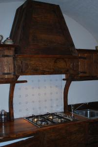 a kitchen with a stove top oven in a kitchen at Baita del Plan in Pragelato