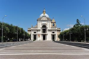 a large white building with a crosswalk in front of it at B&B Raffiori in Assisi